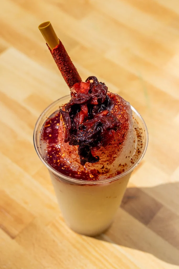 Lime diablito raspado topped with chamoy, chili seasoning, and a tamarind candy stick.
